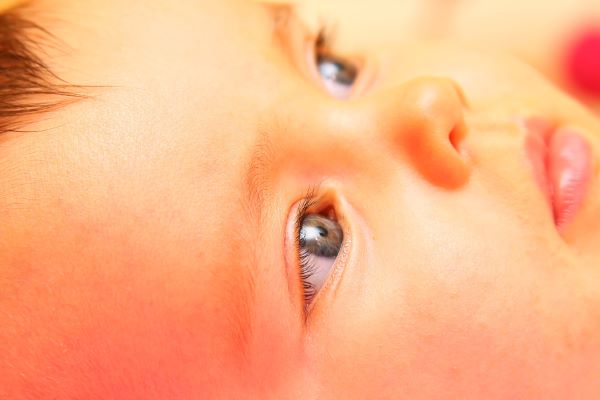 Close do rosto de um bebê com olhos azuis.
Um mito sobre a catarata é o de que ela só atinge adultos. Não, ela também pode atingir os pequenos.